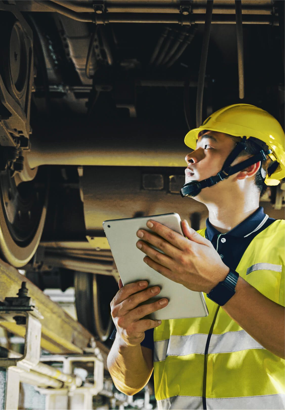 A Welltek engineer inspecting rolling stock with a tablet